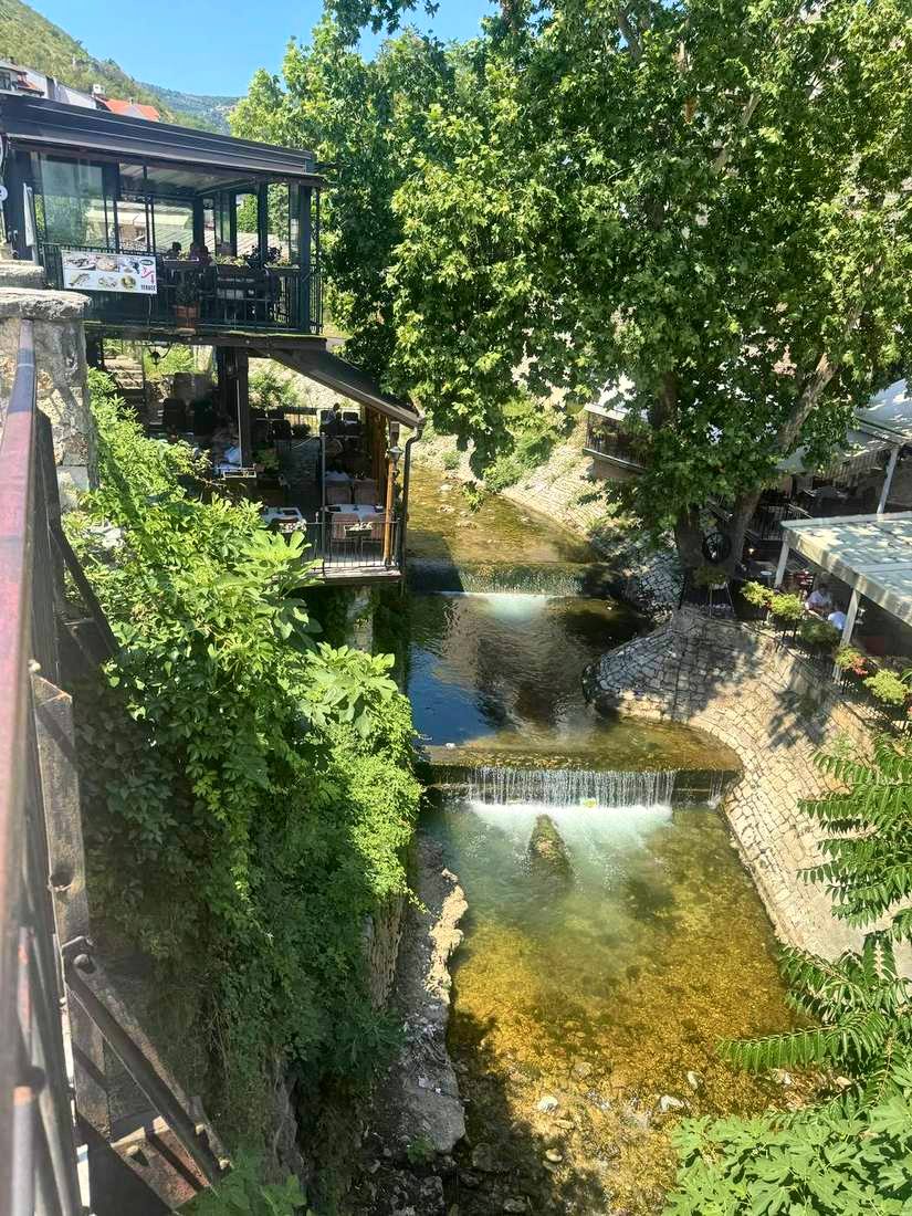 Waterfalls and restaurant decks over the stream