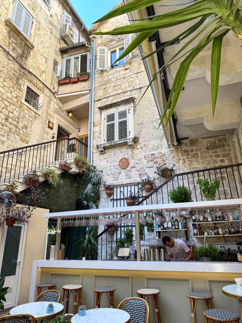 A courtyard bar tucked into the old stone