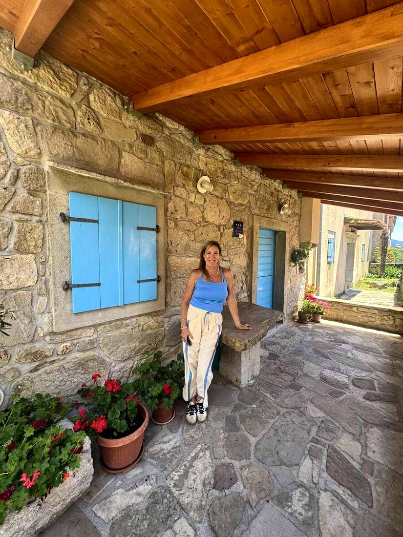 Kelly under the blue shutters