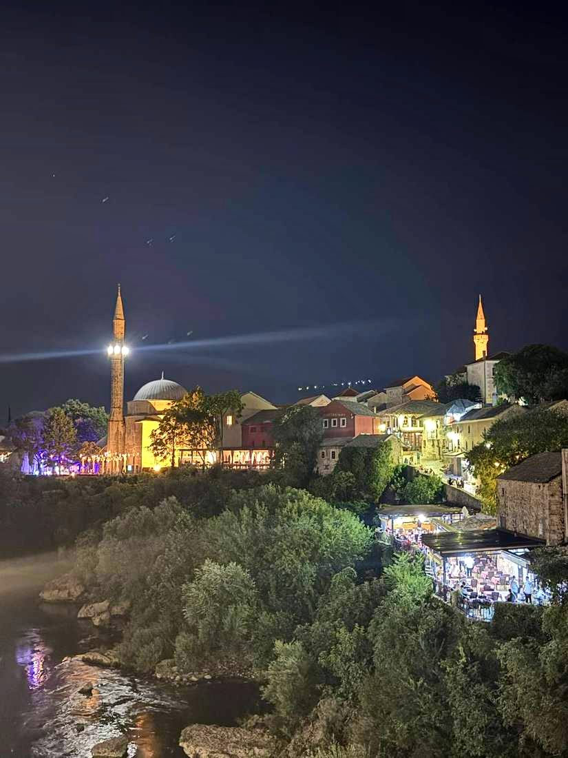 The Koski Mehmed Pasha mosque floodlit over the Neretva