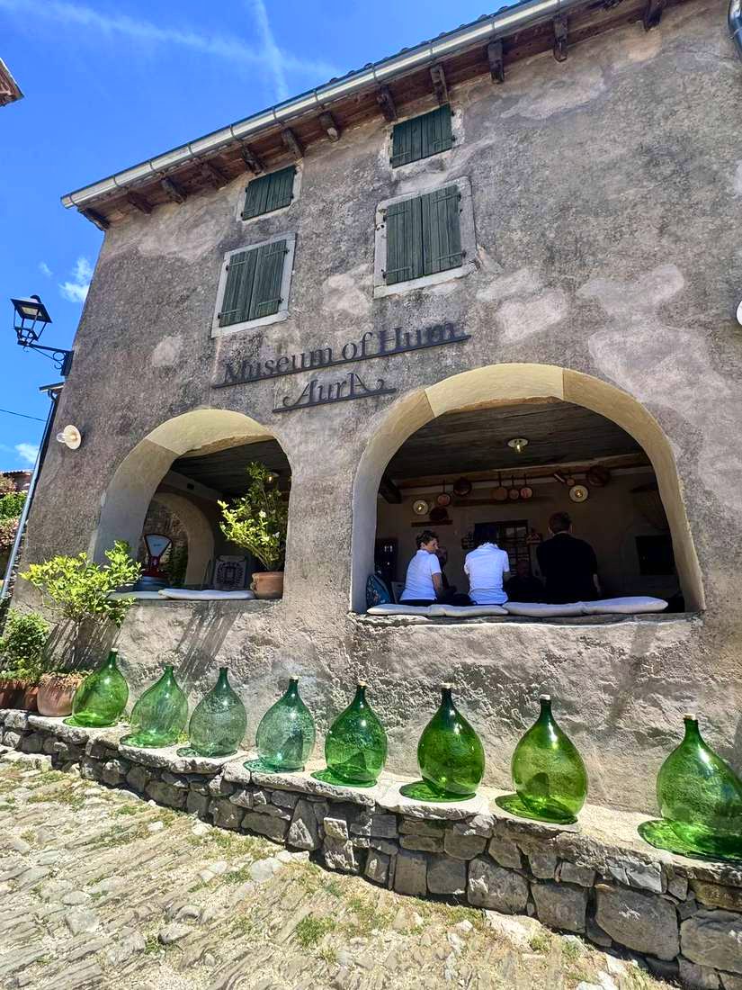 Green demijohns outside the Museum of Hum