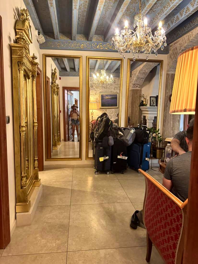 The lobby at Judita Palace, gold mirrors and the bags just dropped