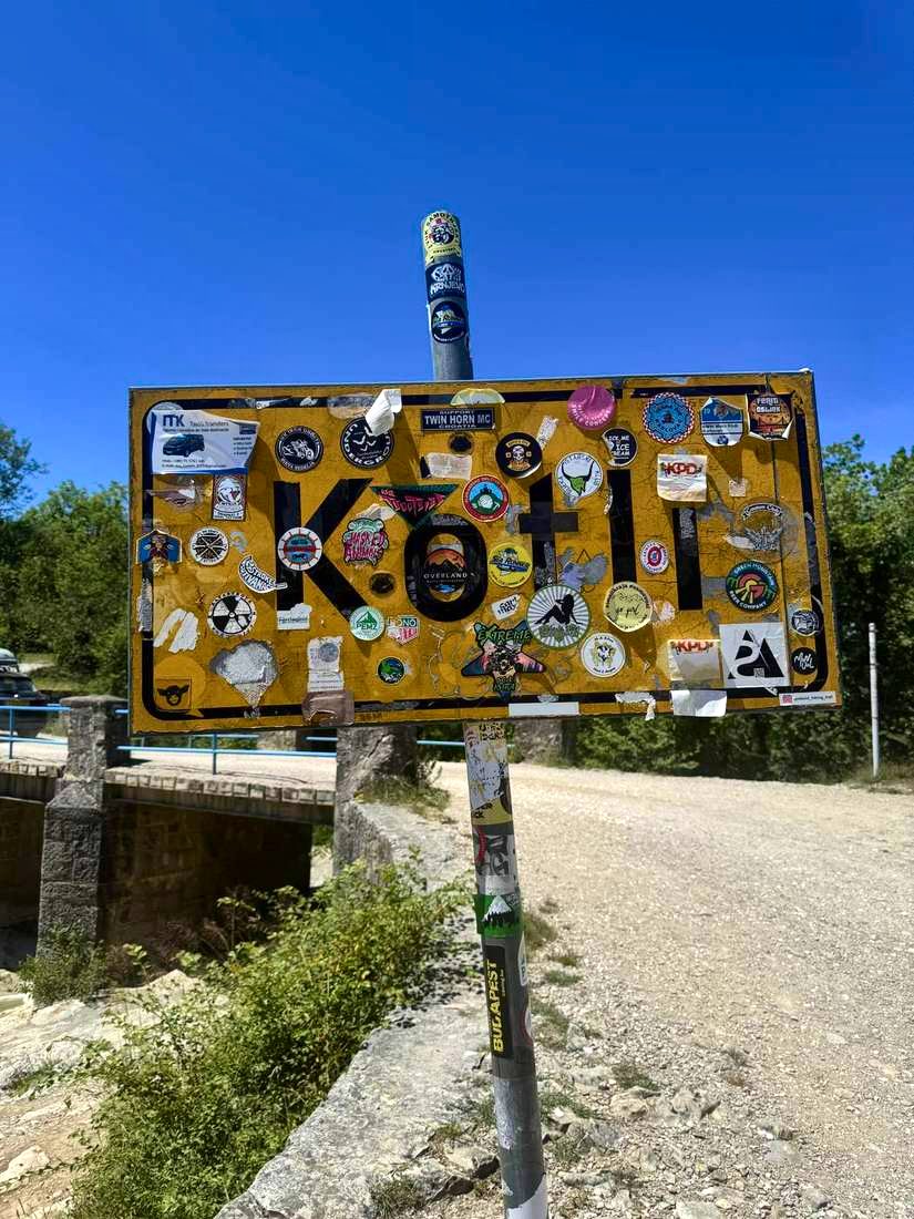 The Kotli sign, and nobody else on the road